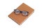 Book in brown cover with reading eyeglass