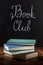 Book Club Concept. A stack of hardcover books with chalk lettering