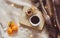 Book, coffee, oranges, chocolate, and Christmas lights on a white and checkered background