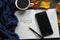 A book with a Cup of tea and a mobile phone surrounded by autumn leaves on a grey background