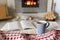 Book and cup of tea near fireplace