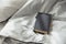 Book gray on a white bedding quilt and sunbeams