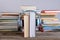 Book with headphone in front of piles of different books