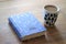 The book 'Little Women' hardcover and a cup of coffee on the wooden table.