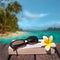 Book and sunglasses, tropical beach