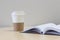 Book turning pages and a paper cup coffee