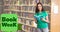 Book week text over portrait of smiling caucasian teenage girl with book standing in library