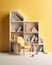 A bookcase filled to the brim with books about the psychological development of children with a e miniature chair for