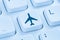 Booking flight holidays vacation online shopping e-commerce internet travel shop blue computer keyboard