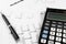 Bookkeeping and accounting business concept, calculator and pen on data sheets