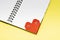 Bookmark heart with eyes for a book on a yellow background close up