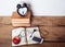 Books, alarm clock, notepad, cellphone with earphones and apple on wooden background