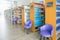 The books on bookshelf and purple chairs in interior library of University