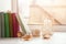 Books, candle and seashells on windowsill