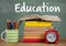 Books on Desk foreground with blackboard Education text