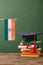 Books, diploma, academic cap and indian flag on wooden surface