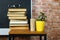 Books, a flower, glasses on a blackboard background. School concept