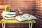 Books and glasses on table with brick wall background outdoors. learning time