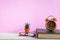 Books and glasses on a white wooden table are clocks and decorations