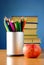 Books, pencils and apple on the table