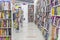 Books on shelves in a store. A large assortment of literature. Blurred. Marking on the floor to maintain customer distance during