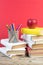 Books stacking. Books on wooden table and red background. Back to school. Copy space for ad text