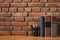 Books and stationary supplies on wooden table with brick wall ba