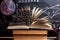 Books on the table against the background of a chalkboard on which are drawn graphs and charts of growth and decline. Business