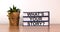 Books with text `whats your story` on beautiful wooden table. House plant. White background. Business concept