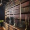 Bookshelf filled with books near a drawer with flower pot, statue and candle on it in