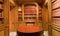 Bookshelves with old volumes of books and antique round table inside the Library