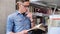 Bookstore. Man Student Reading Books Near Bookshelves