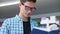 Bookstore. Man Student Reading Books Near Bookshelves