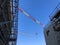 Booms of tower cranes against blue sky. Lifting machinery at construction site
