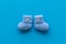 Booties for newborn boy on blue background top view