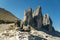 Boots to the mountains for hiking on the background of the Dolomites region Tre Cimme, Italy.