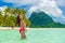 Bora bora luxury vacation travel paradise bikini woman swimming at island in Tahiti, French Polynesia. Popular honeymoon