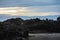 Bord on the rock formation in Karang Bokor Sawarna in Indonesia under blue cloudy sky