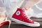 Bordeaux , Aquitaine / France - 11 07 2019 : Bride feet Wedding Dress and red Sneakers converse all star chuck taylor