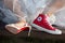 Bordeaux , Aquitaine / France - 11 07 2019 : high heels Bride feet Wedding Dress and red Sneakers converse