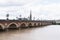 Bordeaux, Gironde / France - 05 26 2019 : Bordeaux southwest France the Pont de Pierre on the Garonne river. The spire Saint