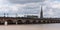 Bordeaux, Gironde / France - 05 26 2019 : Tram Passing over the Pont de Pierre in River Garonne and basilica of Saint Michel