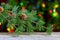 Border from branch of Christmas tree on wood light bokeh