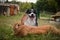 Border collie is lying on the garden with rabbit.