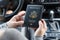 Border control concept.  Woman holding american passport sitting on driver`s seat in car for check customs officers.