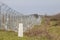 Border fence between Rastina Serbia & Bacsszentgyorgy Hungary with boundary marker.