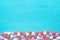 Border Frame from Colorful Sugar Sprinkles Candies Scattered on Light Blue Background. Valentine Romantic Birthday Charity