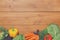 Border of fresh vegetables on wooden background with copy space