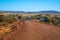 Border between gravel and asphalt road in Western Australia Karijini National Park close to Tom Price