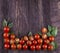 Border made from freshness sliced tomatoes on wood background.